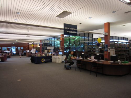 Information Commons Desk with directional sign above