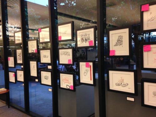 Hanging the Islamic Calligraphy Show on the atrium windows in 2014