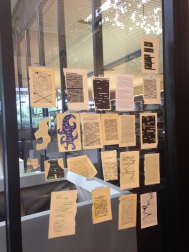 Students began to add their work to the atrium windows after writing poetry in a class session held in the atrium