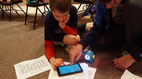 Child playing with iPad and solving a puzzle. 